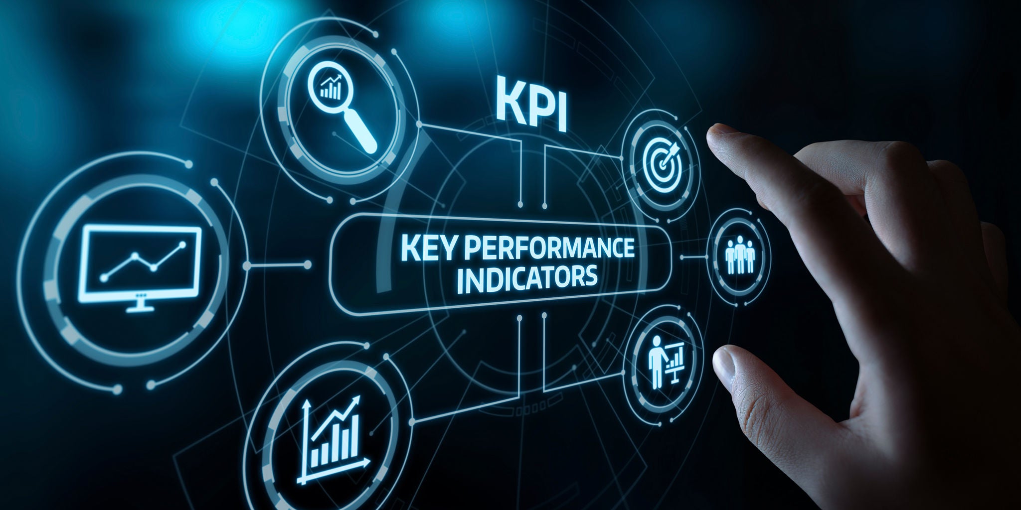 A hand reaches toward a digital interface displaying the term 'Key Performance Indicators' and the abbreviation 'KPI.' The futuristic dashboard features various business-related icons, including graphs, targets, and analytics visuals. The color palette is dominated by cool blue tones, creating a modern and technological atmosphere. The image emphasizes data-driven decision-making and business analytics.