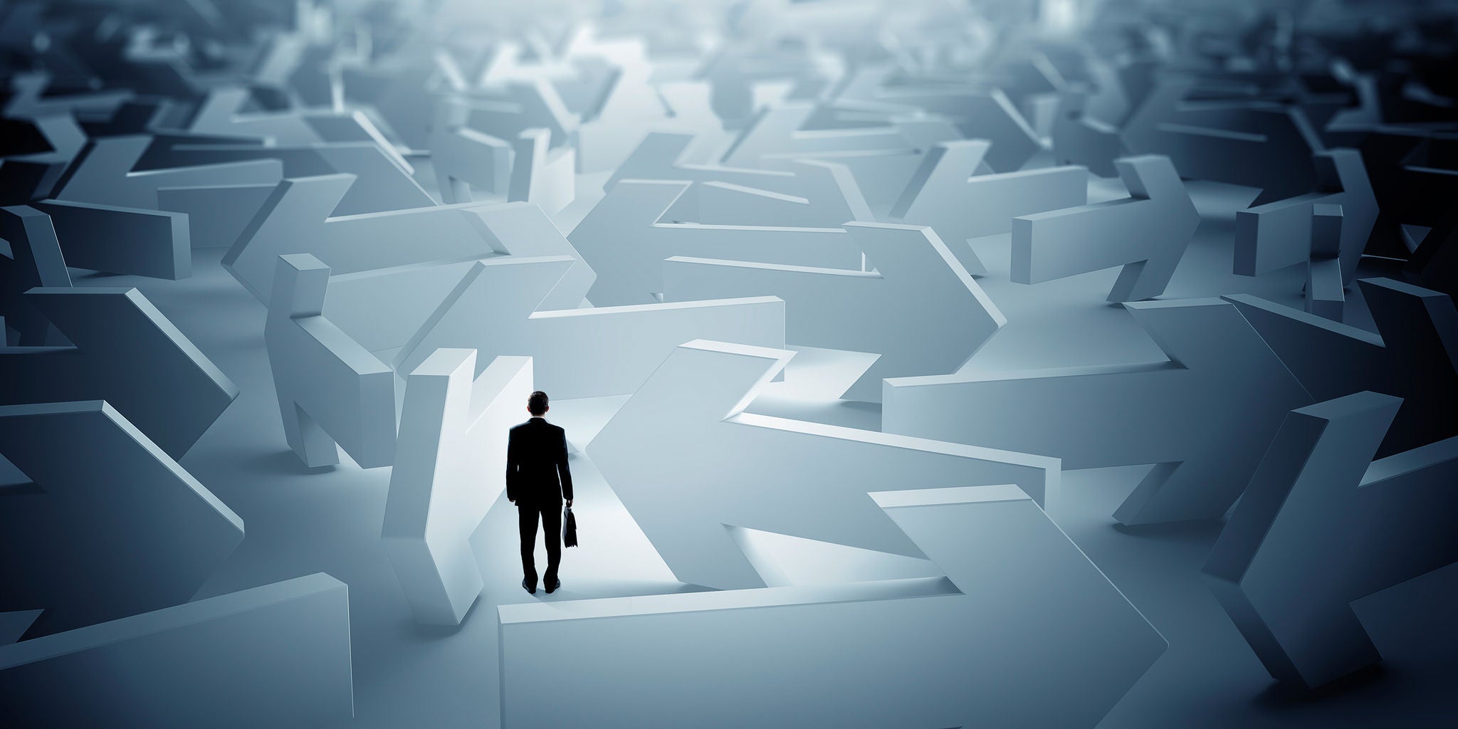 A solitary businessman with a briefcase stands amidst a maze of oversized arrows pointing in various directions. The setting is abstract and surreal, evoking a sense of decision-making and complexity. The color palette is dominated by cool blues and greys, creating a contemplative and serious mood. No visible text or numbers are present in the image.