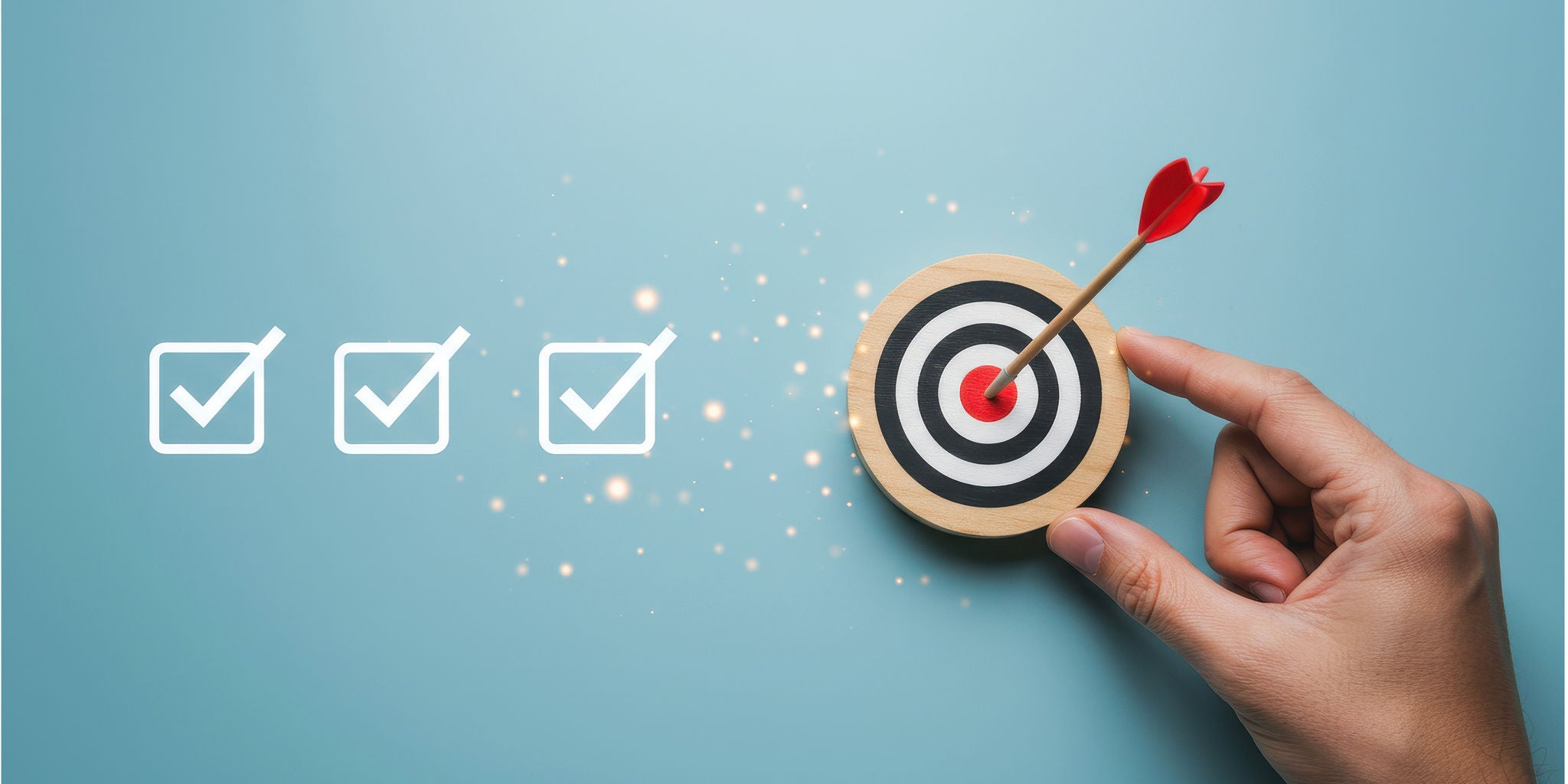 A hand places a red dart on a bullseye target against a blue background. Three checkmarks are aligned to the left, symbolizing goals or tasks completed. The image conveys precision, focus, and achievement in a clean and minimalistic style.