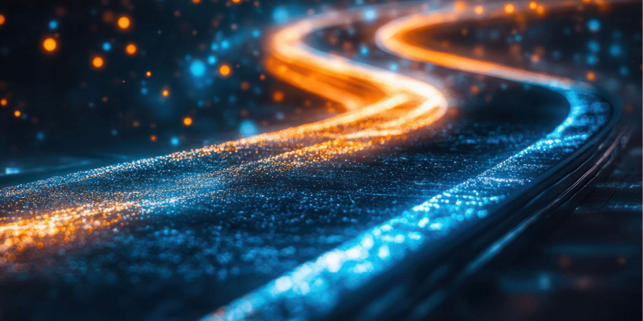 A vibrant, glowing path with blue and orange neon lights creating a dynamic curve. The setting appears futuristic, with sparkling textures and a bokeh effect in the background. The image conveys a sense of motion and energy, enhanced by the vivid color palette.