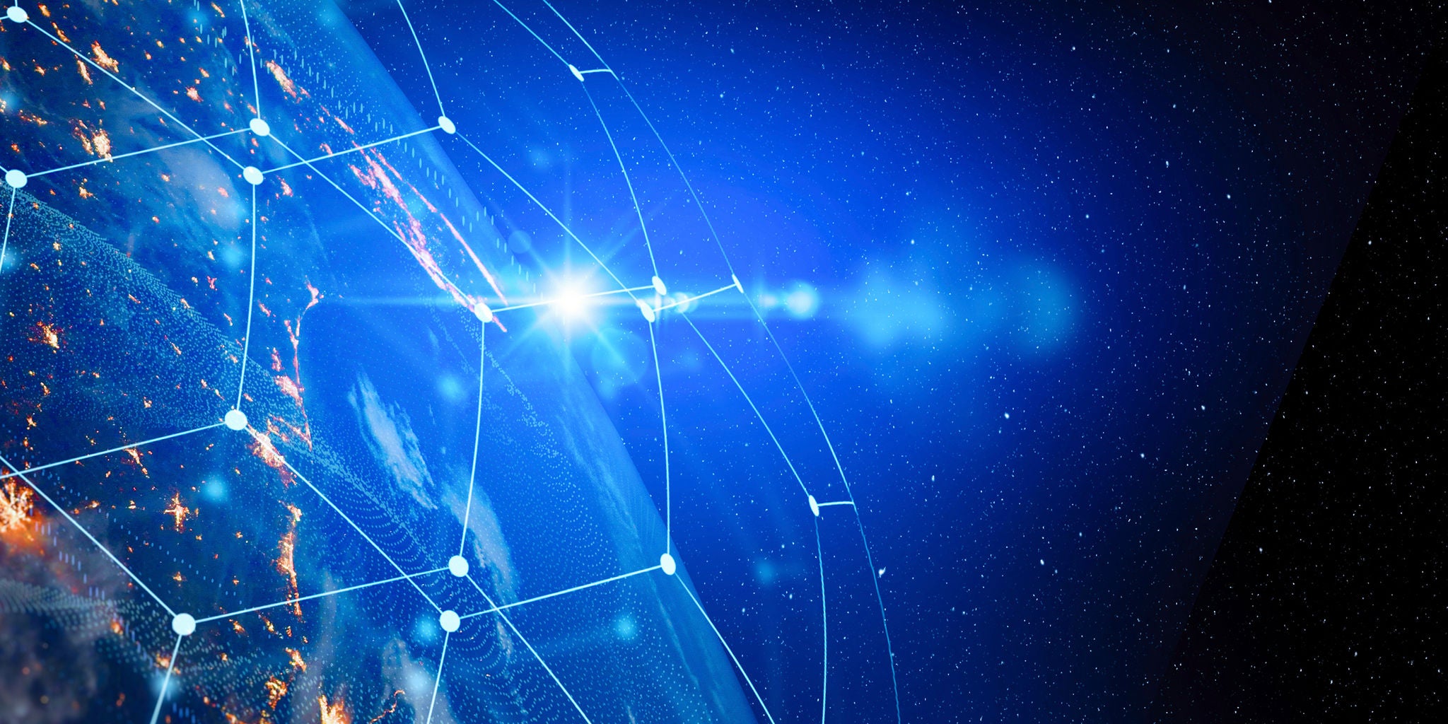 A view of Earth from outer space features a glowing sunrise on the horizon. A digital network grid overlays the planet, symbolizing global connectivity and technology. The image uses a vibrant blue palette with illuminated city lights visible on the surface. No people or text are present in the scene.
